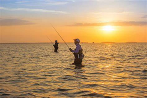 Two men fishing in the ocean