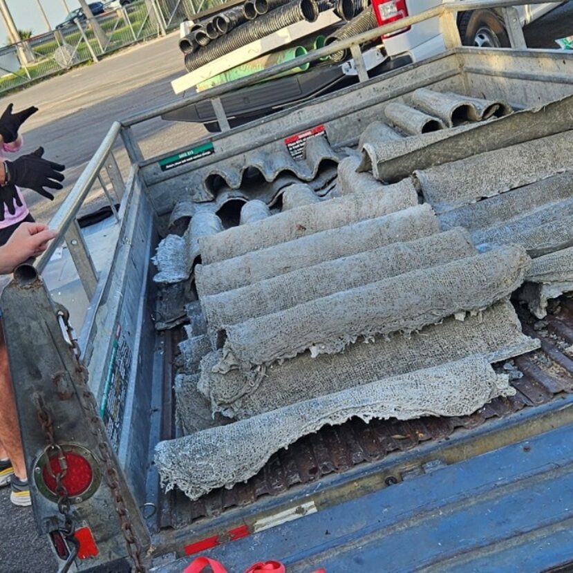 People unloading items from the back of a trailer