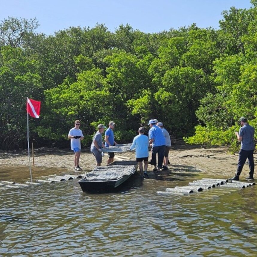 People standing around a boat on a shore