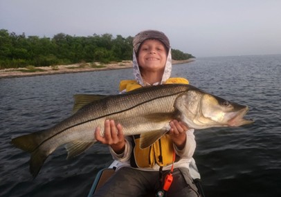 A child holding a large fish