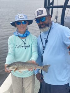 A man and a child holding a fish
