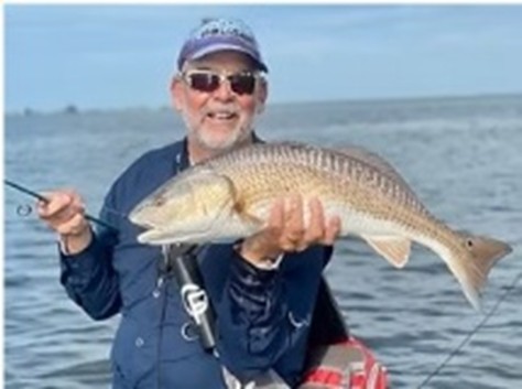 Wader Dave holding a fish